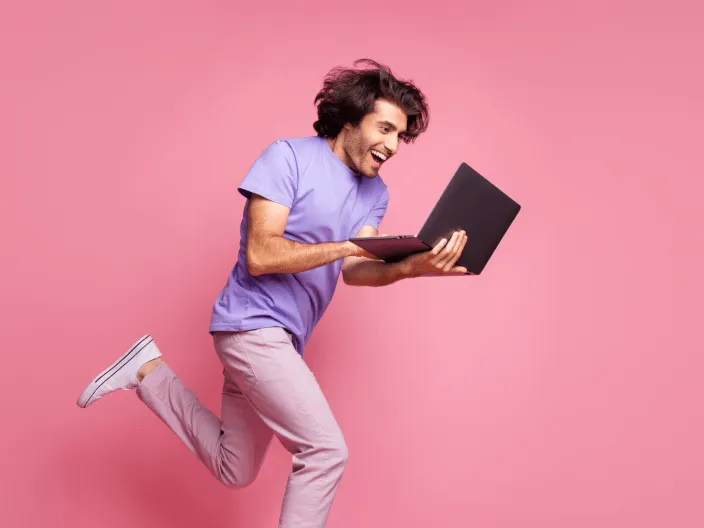 Happy man running with laptop