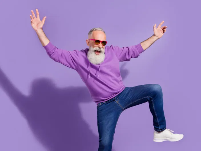 Happy dancing man with jeans and sunglasses